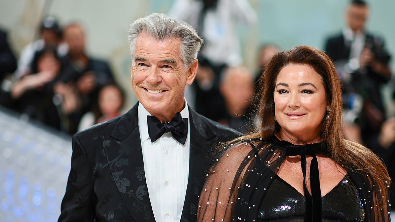 Pierce Brosnan et Keely Shaye Smith marchant main dans la main