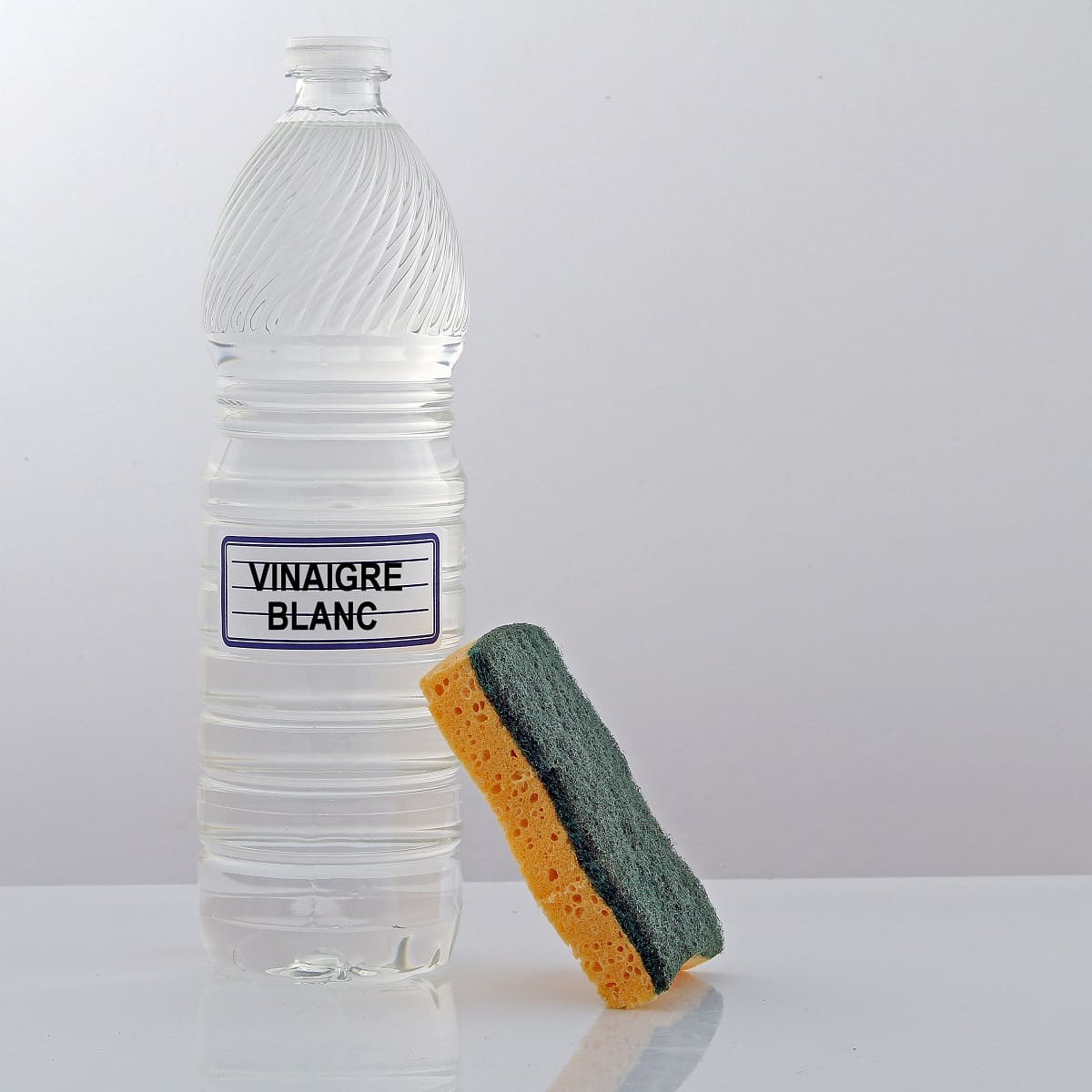 Flacon de vinaigre blanc et éponge